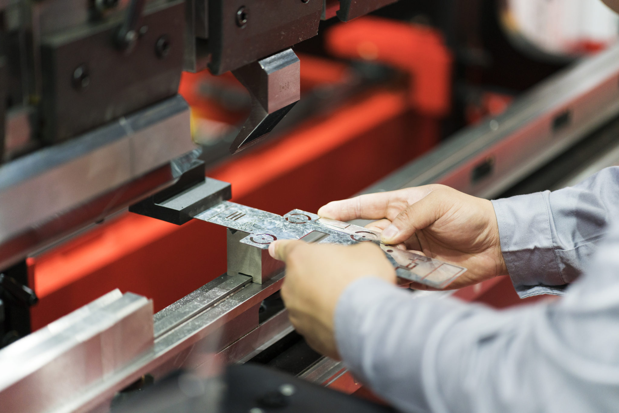 operator bending metal sheet by sheet bending machine Operator bending sheet metal for precision machining